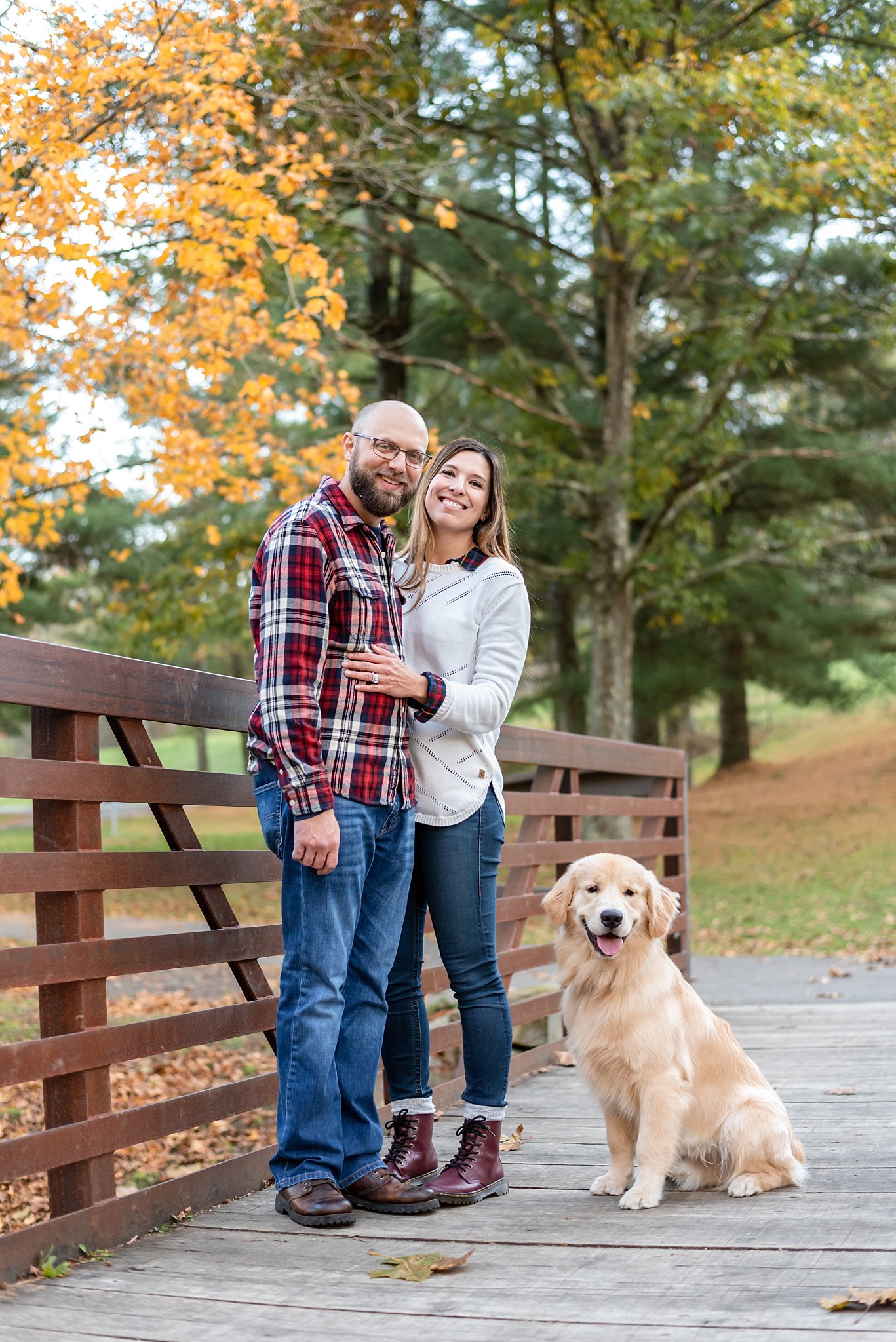 young couple with their golden retriever puppy at Mingo Creek Park