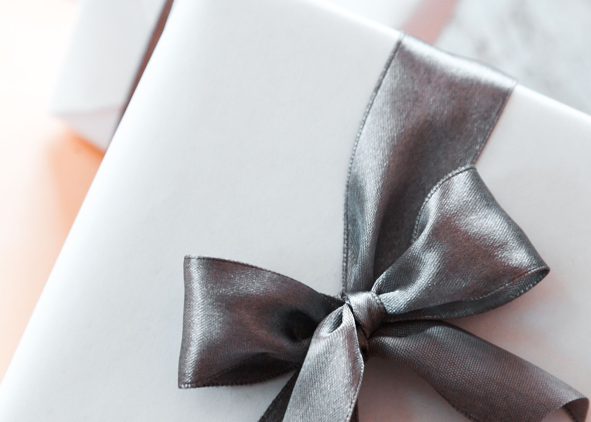 white wrapped gift with silver bow