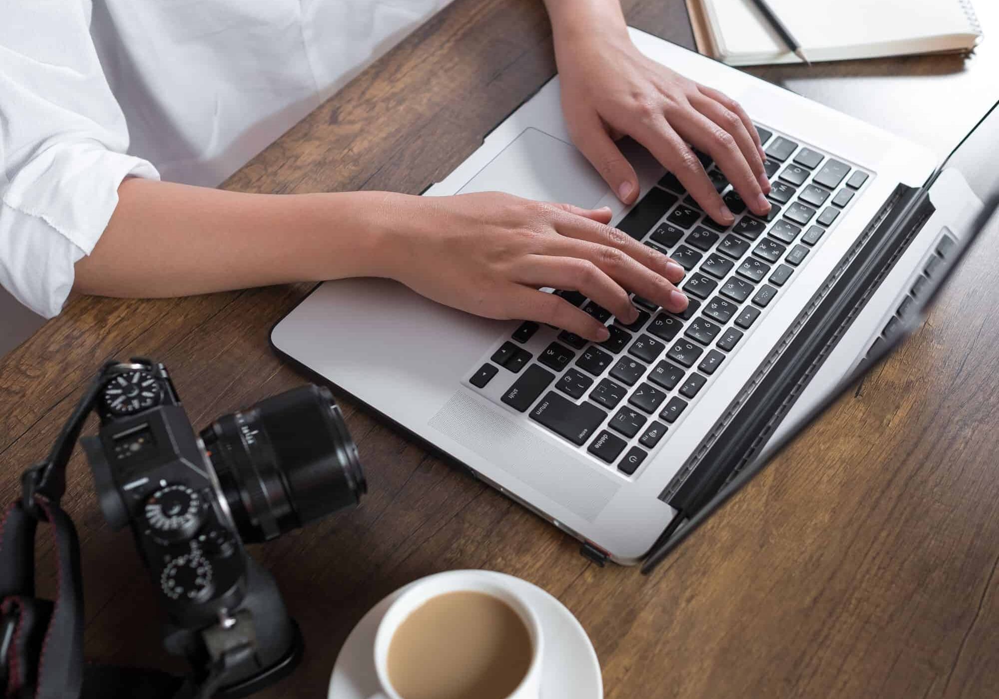 female-photographer-typing-on-laptop